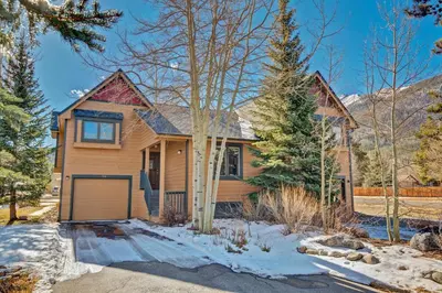 a house with a garage in the snow at Pitkin Townhome 704 in Frisco