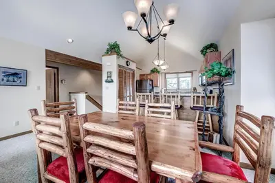 a kitchen and dining room with a wooden table and chairs at Pitkin Townhome 704 in Frisco