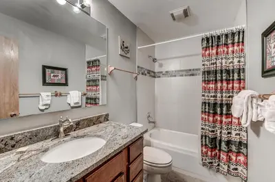 a bathroom with a sink and a toilet and a shower at Pitkin Townhome 704 in Frisco