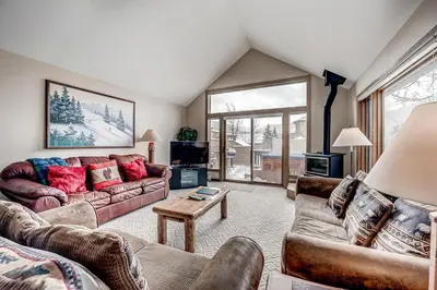 a living room with two couches and a tv at Pitkin Townhome 704 in Frisco