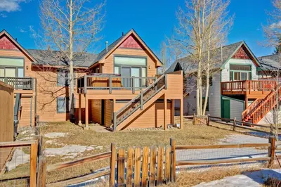 a home with a wooden fence in front of it at Pitkin Townhome 704 in Frisco