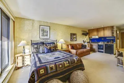 a large bedroom with a bed and a kitchen at Cedar Lodge 309 in Frisco