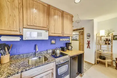 a kitchen with a sink and a stove top oven at Cedar Lodge 309 in Frisco