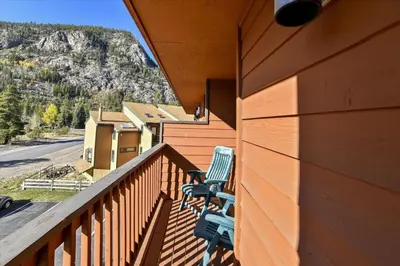 a balcony of a house with two chairs on it at Cedar Lodge 309 in Frisco