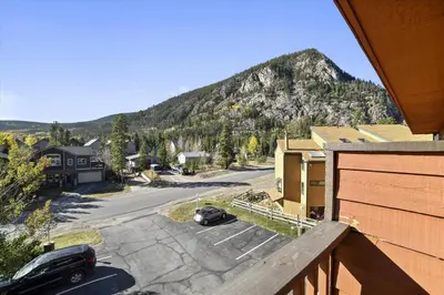 a car parked in a parking lot in front of a mountain at Cedar Lodge 309 in Frisco