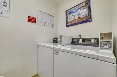 a white room with a machine and a microwave at Cedar Lodge 309 in Frisco
