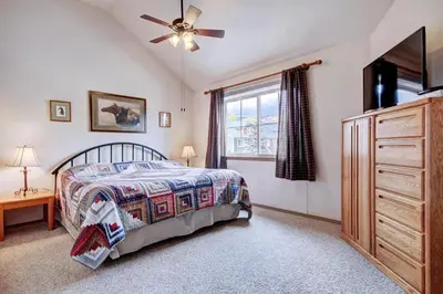 a bedroom with a bed and a ceiling fan at Tarn Landing C-4 in Frisco