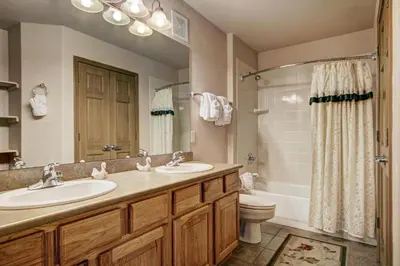 a bathroom with two sinks and a shower and a toilet at Tarn Landing C-4 in Frisco