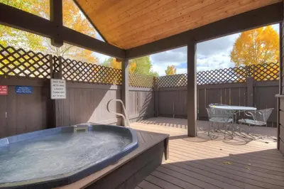 a large hot tub on a deck with a table at Tarn Landing C-4 in Frisco