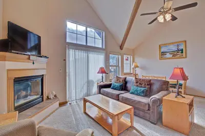 a living room with a couch and a fireplace at Tarn Landing C-4 in Frisco