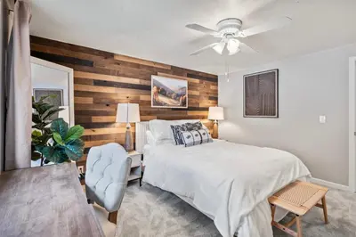 a bedroom with a bed and a ceiling fan at Whispering Pines-Hot tub Getaway in Bailey