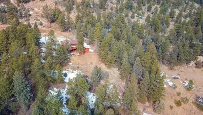 an aerial view of a house in the middle of a forest at Whispering Pines-Hot tub Getaway in Bailey
