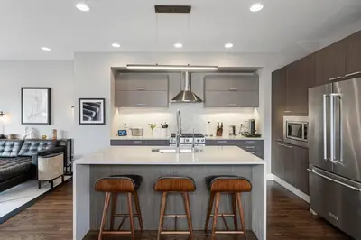 a kitchen with a large island with two bar stools at Luxury Home: Monthly Rental House Near Denver in Englewood