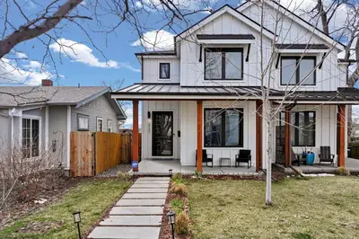 a white house with a fence in the yard at Luxury Home: Monthly Rental House Near Denver in Englewood