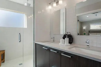 a bathroom with a double sink and a shower at Luxury Home: Monthly Rental House Near Denver in Englewood