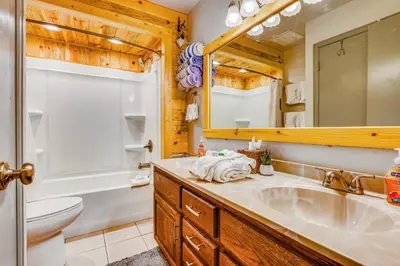 a bathroom with a sink and a toilet and a mirror at 2 Mi to Granby Ranch Dog-Friendly Studio! in Granby