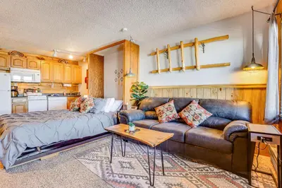a living room with a bed and a couch at 2 Mi to Granby Ranch Dog-Friendly Studio! in Granby