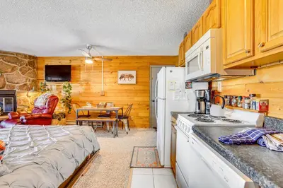 a kitchen with a bed and a table in a room at 2 Mi to Granby Ranch Dog-Friendly Studio! in Granby