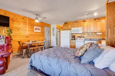 a bedroom with a bed and a kitchen with a table at 2 Mi to Granby Ranch Dog-Friendly Studio! in Granby
