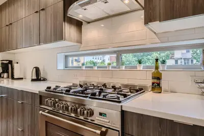 a kitchen with a stove and a bottle of wine at Upscale Townhome w/ Stunning Rooftop Views in Denver