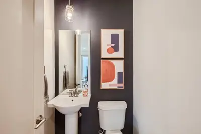 a bathroom with a sink and a toilet and a mirror at Upscale Townhome w/ Stunning Rooftop Views in Denver