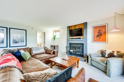 a living room with two couches and a fireplace at Fraser Condo with Ski Shuttle and Resort Amenities! in Fraser