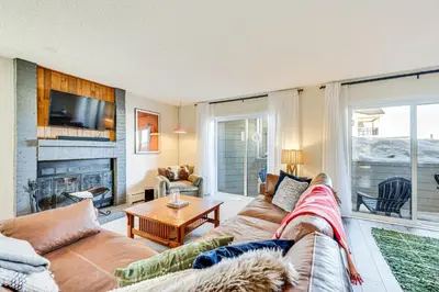 a living room with a couch and a fireplace at Fraser Condo with Ski Shuttle and Resort Amenities! in Fraser