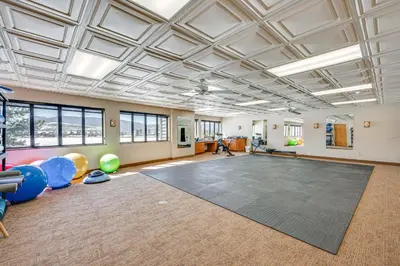 a large room with a gym with a lot of exercise equipment at Fraser Condo with Ski Shuttle and Resort Amenities! in Fraser