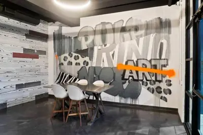 a dining room with a table and four chairs at Graffiti & Skyline | RiNo Art Lofts in Denver