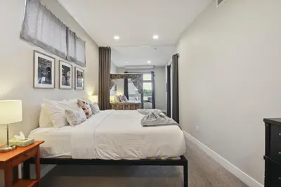 a bedroom with a large bed and a table at Graffiti & Skyline | RiNo Art Lofts in Denver