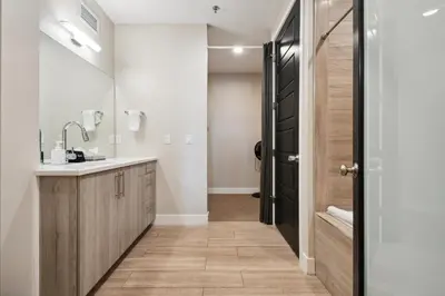 a bathroom with a sink and a shower at Graffiti & Skyline | RiNo Art Lofts in Denver