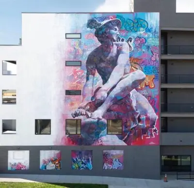 a painting of a woman on the side of a building at Graffiti & Skyline | RiNo Art Lofts in Denver