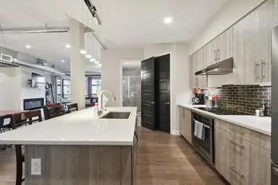 a kitchen with a sink and a counter top at Graffiti & Skyline | RiNo Art Lofts in Denver