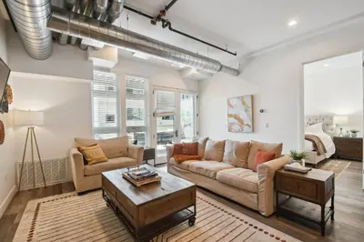 a living room with a couch and a table at Brushed & Bold | RiNo Art Lofts in Denver