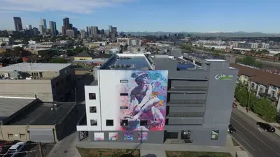 a building with a large painting on the side of it at Brushed & Bold | RiNo Art Lofts in Denver