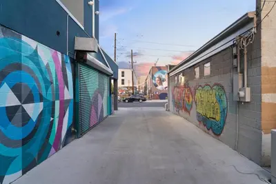 a hallway with graffiti on the side of a building at Brushed & Bold | RiNo Art Lofts in Denver