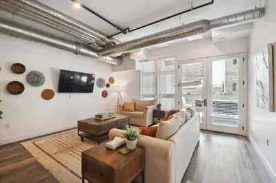 a living room with a couch and a table at Brushed & Bold | RiNo Art Lofts in Denver