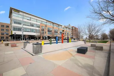 a park in front of a building with at Uptown Avenue - Broomfield in Broomfield