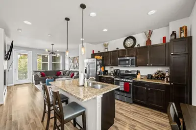 a kitchen and living room with a counter top at Uptown Avenue - Broomfield in Broomfield