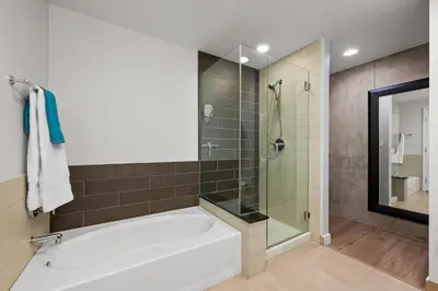 a bathroom with a tub and a glass shower at Spire - Unit 1810 in Denver