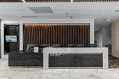 a lobby with a reception desk with a star sign at Spire - Unit 1810 in Denver