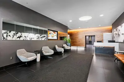 an office lobby with chairs and a reception desk at Spire - Unit 1810 in Denver