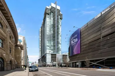 a car is parked in front of a tall building at Spire - Unit 1810 in Denver