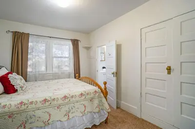 a bedroom with a bed and a window and a door at O'Deer Cabin - Pet Friendly - Estes Park -- EV#3241 cabin in Estes Park