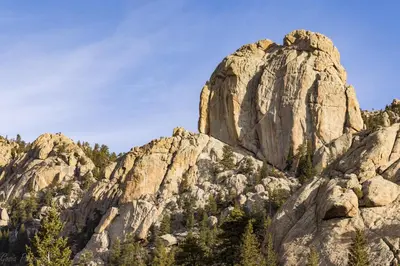 a rocky mountain with trees in front of it at O'Deer Cabin - Pet Friendly - Estes Park -- EV#3241 cabin in Estes Park