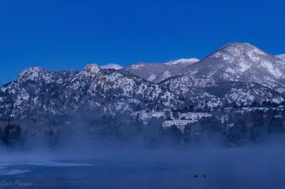 a snowy mountain range with a town in the middle of a lake at Chasm Cabin -- 20-NCD0048 cabin in Estes Park