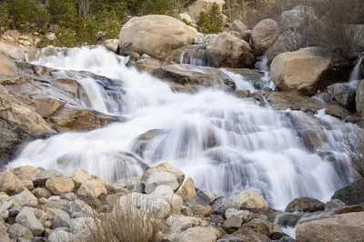 a stream of water flowing over rocks in a river at Chasm Cabin -- 20-NCD0048 cabin in Estes Park