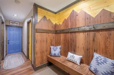 a wooden wall with two pillows on a wooden bench at Eldondale -- 22-ZONE3272 home in Estes Park