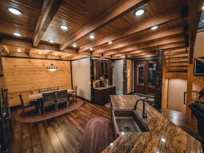 a kitchen and dining room in a log cabin at Eldondale -- 22-ZONE3272 home in Estes Park