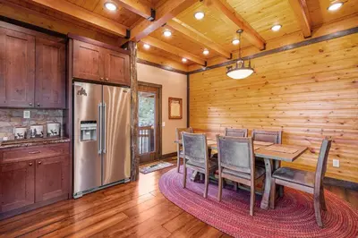 a dining room with a table and a refrigerator at Eldondale -- 22-ZONE3272 home in Estes Park
